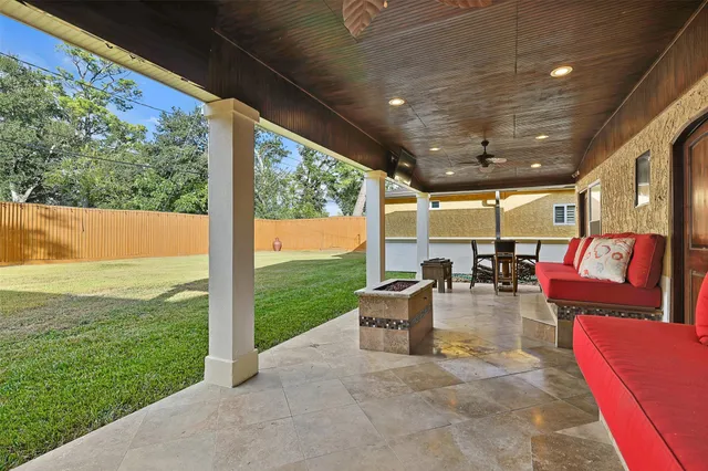a living room with patio furniture and a floor to ceiling window