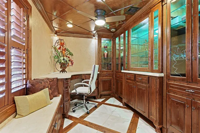 a view of a livingroom with workspace and a window