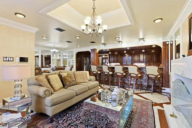 a living room with lots of furniture and chandelier