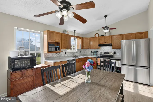 a kitchen with a refrigerator and a sink
