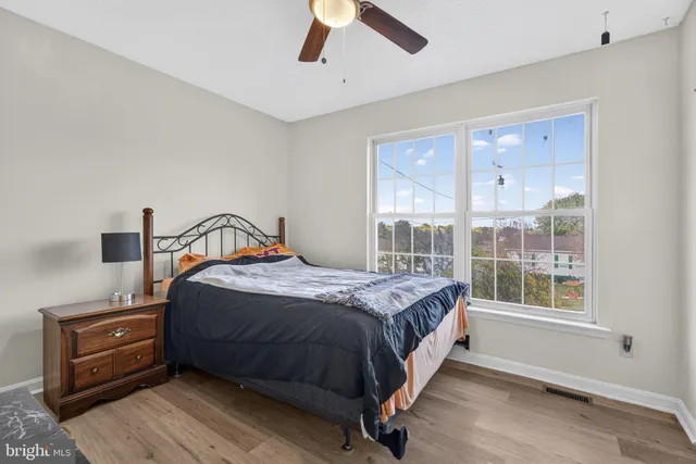 a view of residential houses with yard and green space