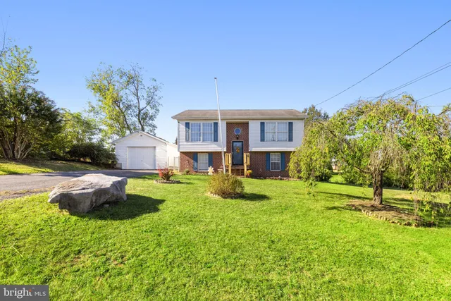 a view of a house with swimming pool and sitting area