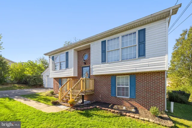 a view of a green field with wooden fence