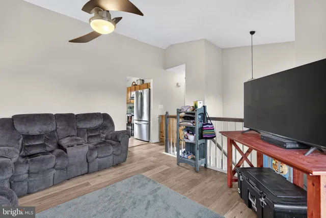 a living room with furniture a flat screen tv and a couch