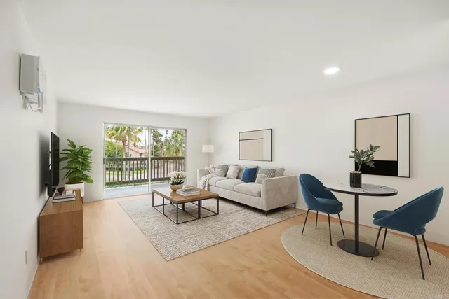 a living room with furniture large window and flat screen tv