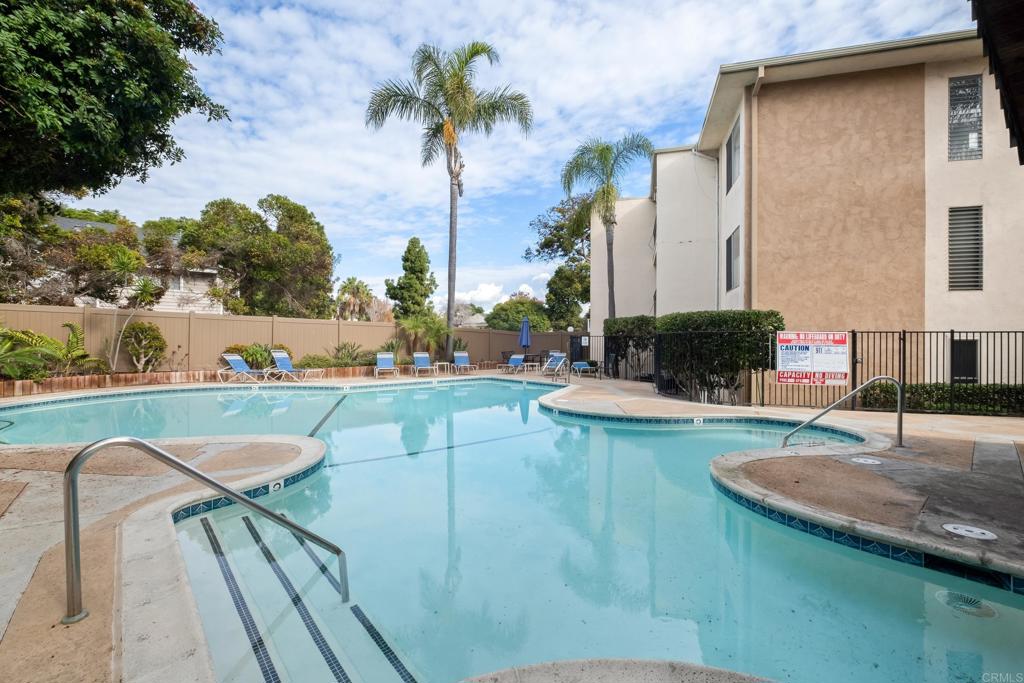 4444 West Point Loma Boulevard, Unit 122 San Diego, CA 92107 - Photo 24 of 25 a view of a swimming pool with a patio and a garden