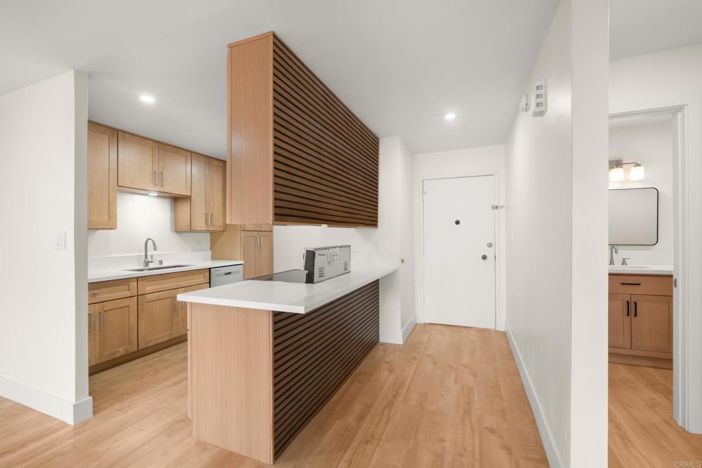 4444 West Point Loma Boulevard, Unit 122 San Diego, CA 92107 - Photo 10 of 25 a kitchen with a sink stove and refrigerator