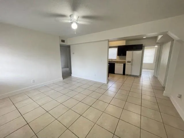 a view of a kitchen with a sink and a refrigerator