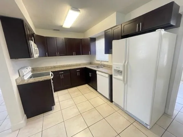 a kitchen with stainless steel appliances a refrigerator sink and cabinets