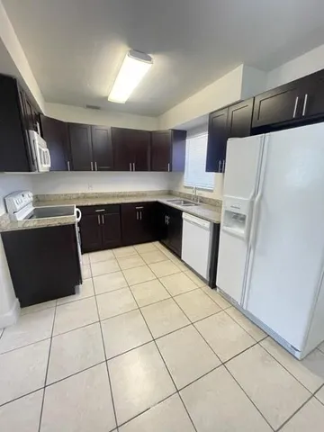 a kitchen with stainless steel appliances a sink and a refrigerator