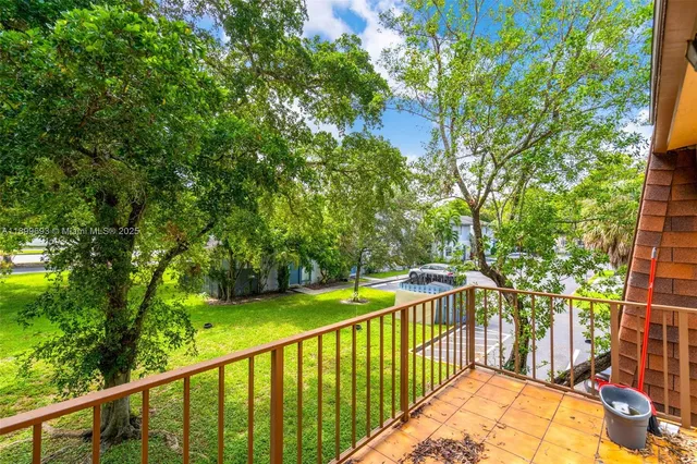a view of balcony with yard