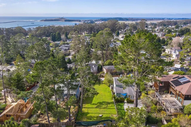 an aerial view of a houses with a yard