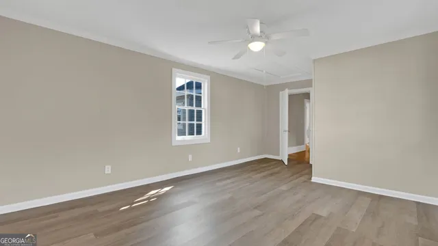 wooden floor in an empty room with a window