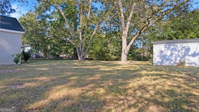 a view of backyard with large trees