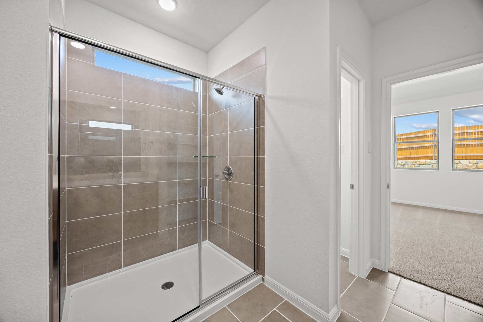 200 Hornet Street Elgin, TX 78621 - Photo 18 of 39 a bathroom with a glass shower door