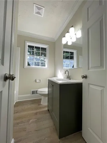 a bathroom with a double vanity sink toilet and a mirror