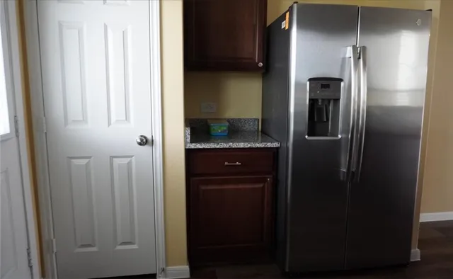 a kitchen with a refrigerator and cabinets