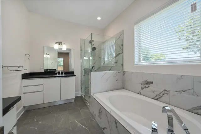 a bathroom with a bathtub and a sink