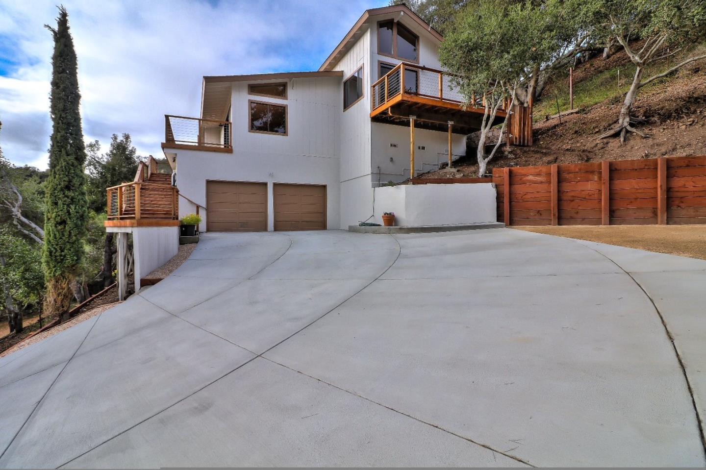 11551 Hidden Valley Road Carmel Valley, CA 93924 - Photo 1 of 33 a front view of a house with garage