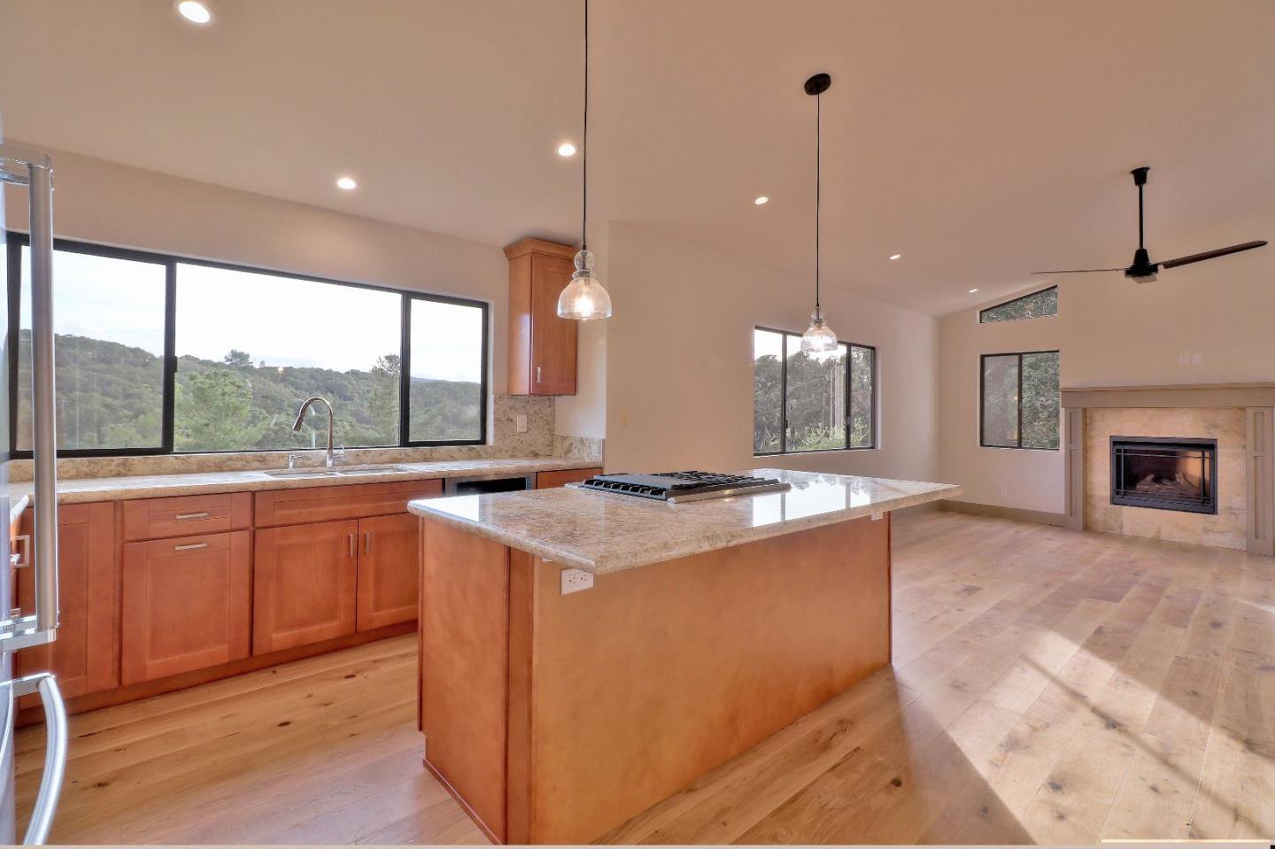 11551 Hidden Valley Road Carmel Valley, CA 93924 - Photo 11 of 33 a kitchen with kitchen island a stove a sink a center island and windows
