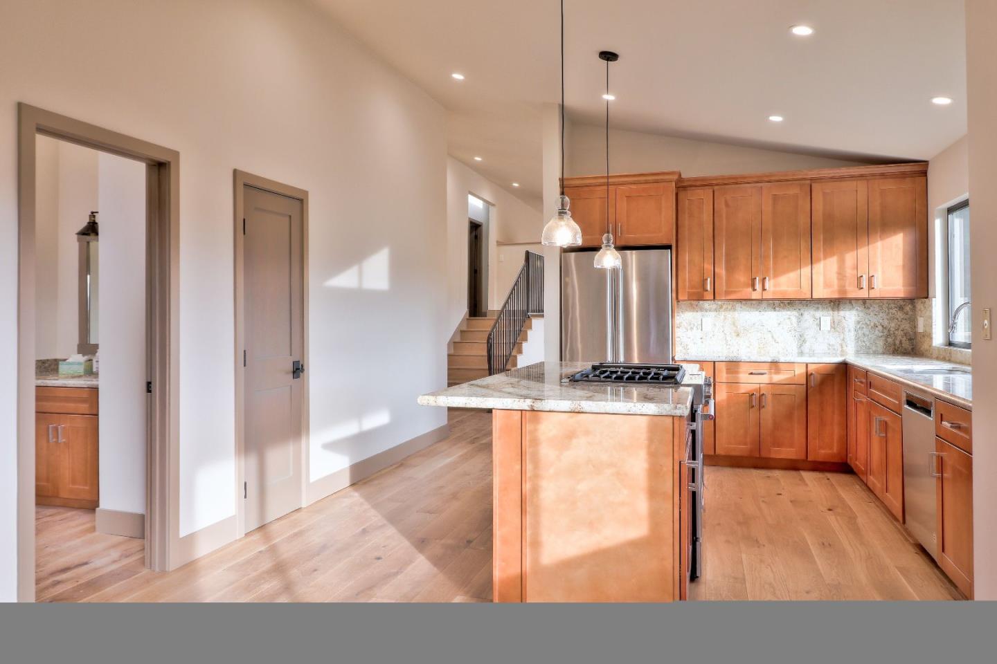 11551 Hidden Valley Road Carmel Valley, CA 93924 - Photo 12 of 33 a kitchen with stainless steel appliances granite countertop wooden cabinets a stove a sink and a large window