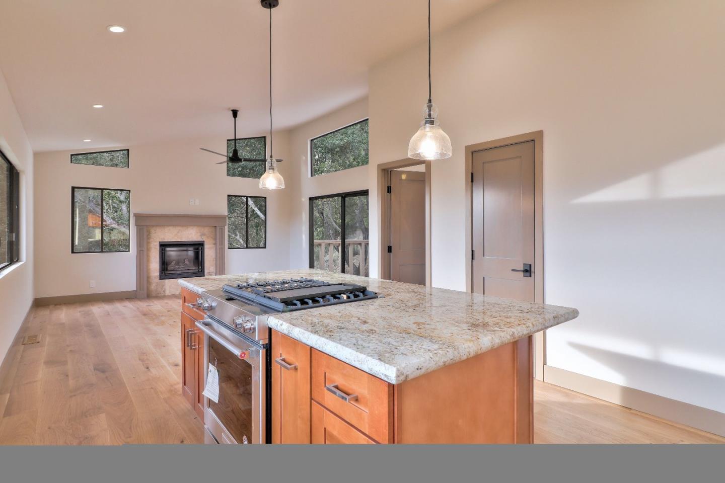 11551 Hidden Valley Road Carmel Valley, CA 93924 - Photo 13 of 33 a kitchen view of a kitchen island a stove a sink a center island and a wooden floor