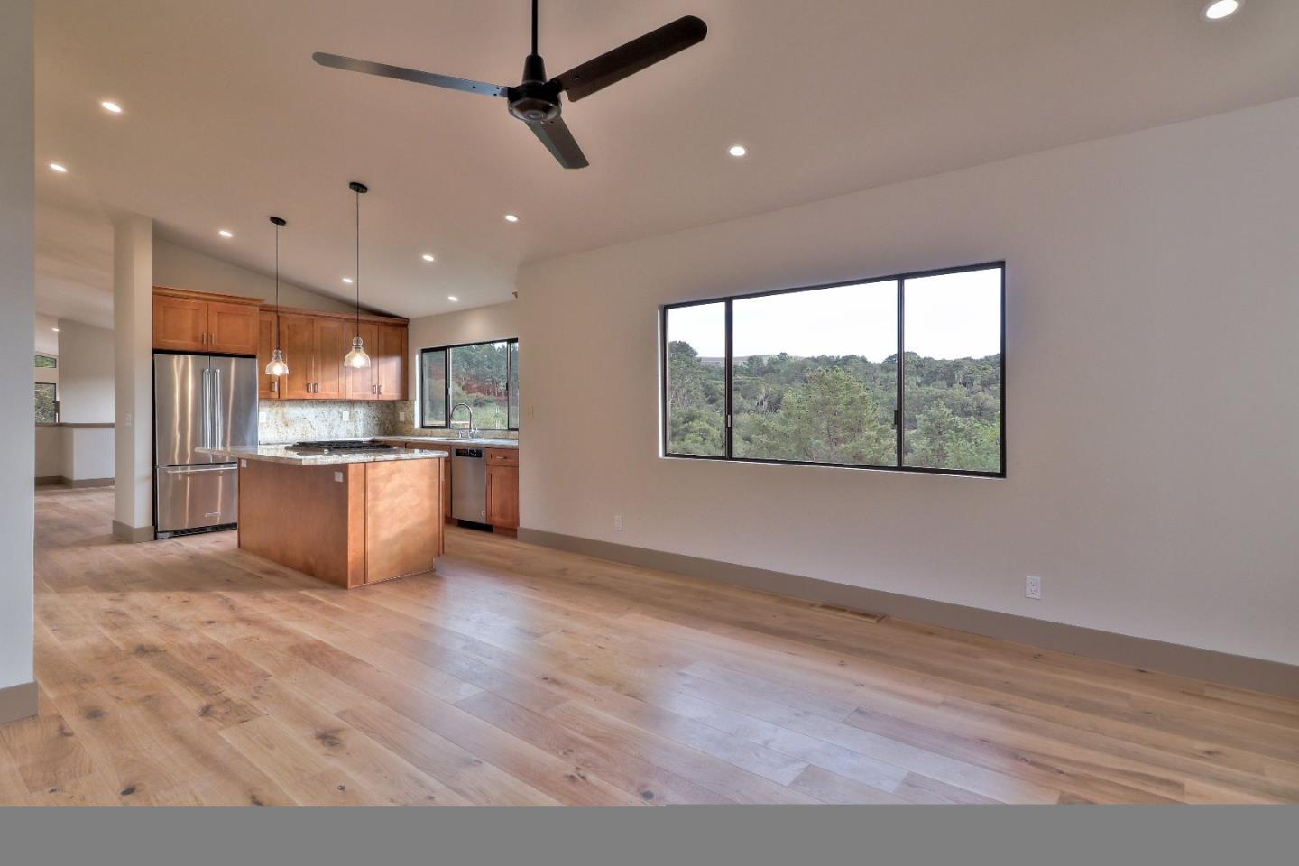 11551 Hidden Valley Road Carmel Valley, CA 93924 - Photo 16 of 33 a view of kitchen with kitchen island stainless steel appliances wooden floor and window