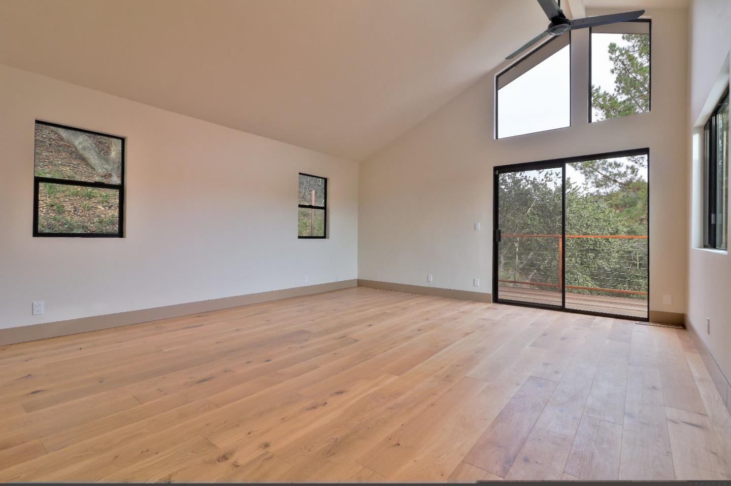 11551 Hidden Valley Road Carmel Valley, CA 93924 - Photo 18 of 33 a view of an empty room with wooden floor and a window