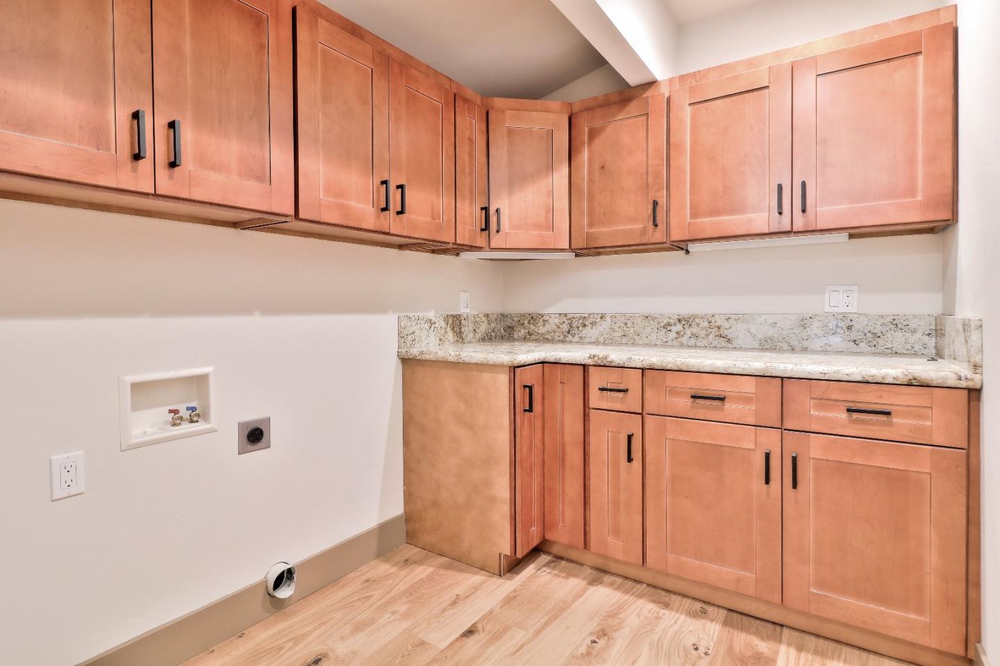 11551 Hidden Valley Road Carmel Valley, CA 93924 - Photo 28 of 33 a kitchen with granite countertop stainless steel appliances white cabinets and a sink