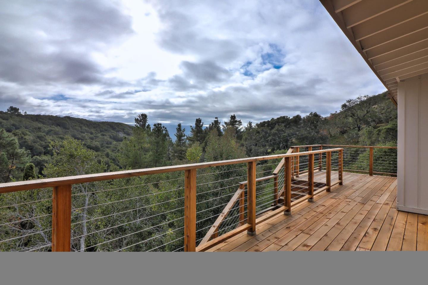 11551 Hidden Valley Road Carmel Valley, CA 93924 - Photo 3 of 33 a view of a balcony with wooden floor and fence