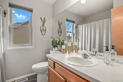 a bathroom with a toilet a sink and a mirror