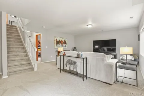 a view of a livingroom with furniture and a flat screen tv
