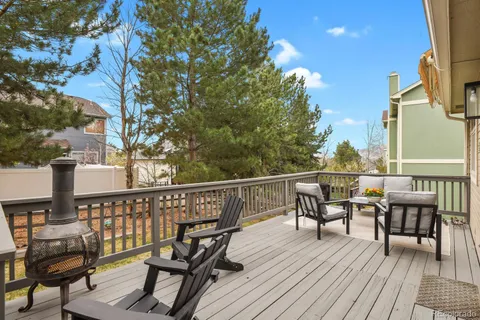 a wooden deck with outdoor seating and yard