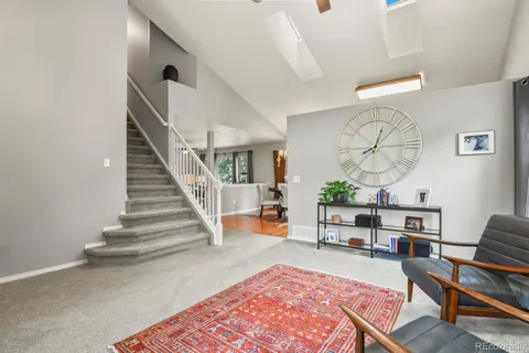 a living room with furniture and a clock
