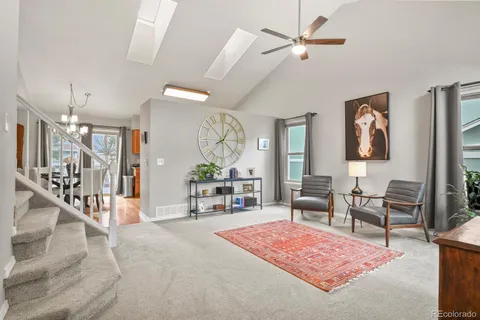 a living room with furniture a rug and a chandelier