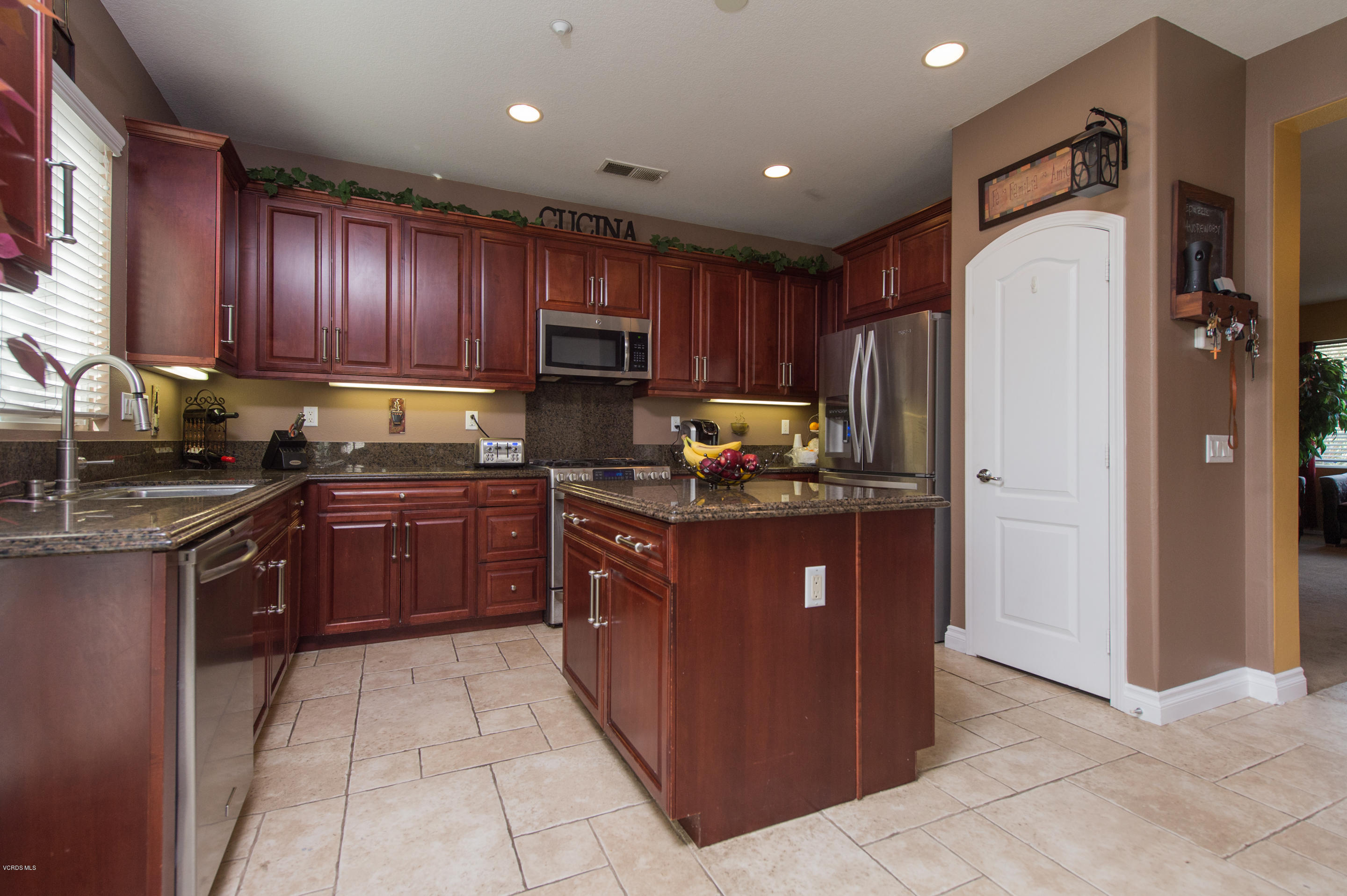 615 Halifax Lane Oxnard, CA 93035 - Photo 4 of 12 a kitchen with granite countertop wooden cabinets and stainless steel appliances
