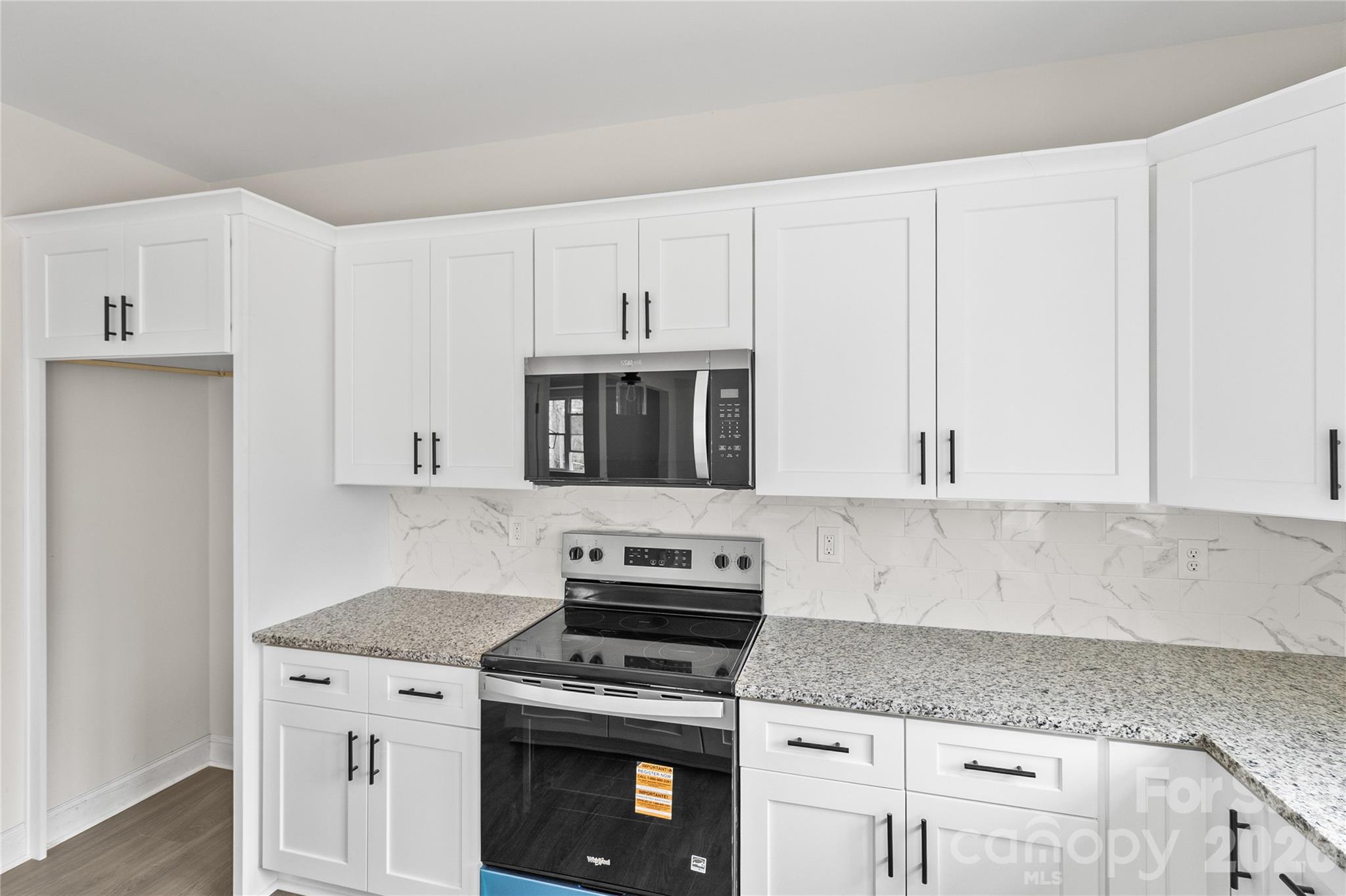 3692 Shannon Loop Denver, NC 28037 - Photo 4 of 47 a kitchen with granite countertop a stove a sink and a white cabinets