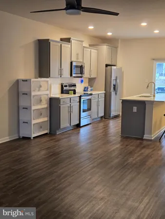 a kitchen with stainless steel appliances a refrigerator and a stove top oven
