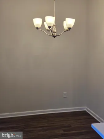 a view of room with wooden floor
