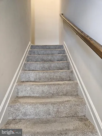 a view of staircase with white walls