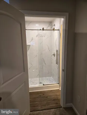 a bathroom with a glass shower door
