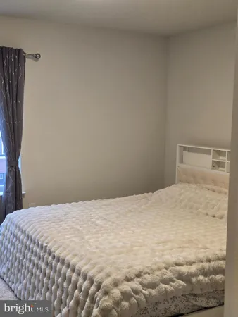 a large white bed in a white room