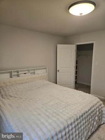 a bedroom with a bed and a chair