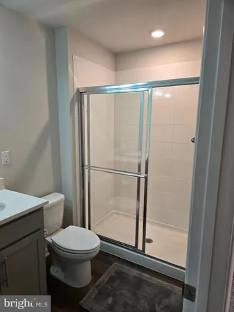 a bathroom with a toilet a sink and shower