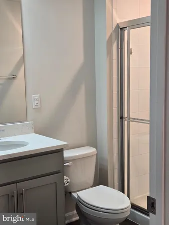 a bathroom with a toilet a sink and a mirror