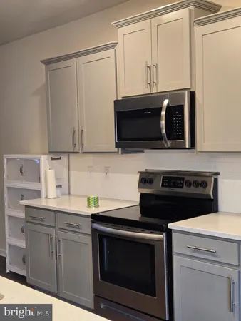 a kitchen with cabinets stainless steel appliances and a sink