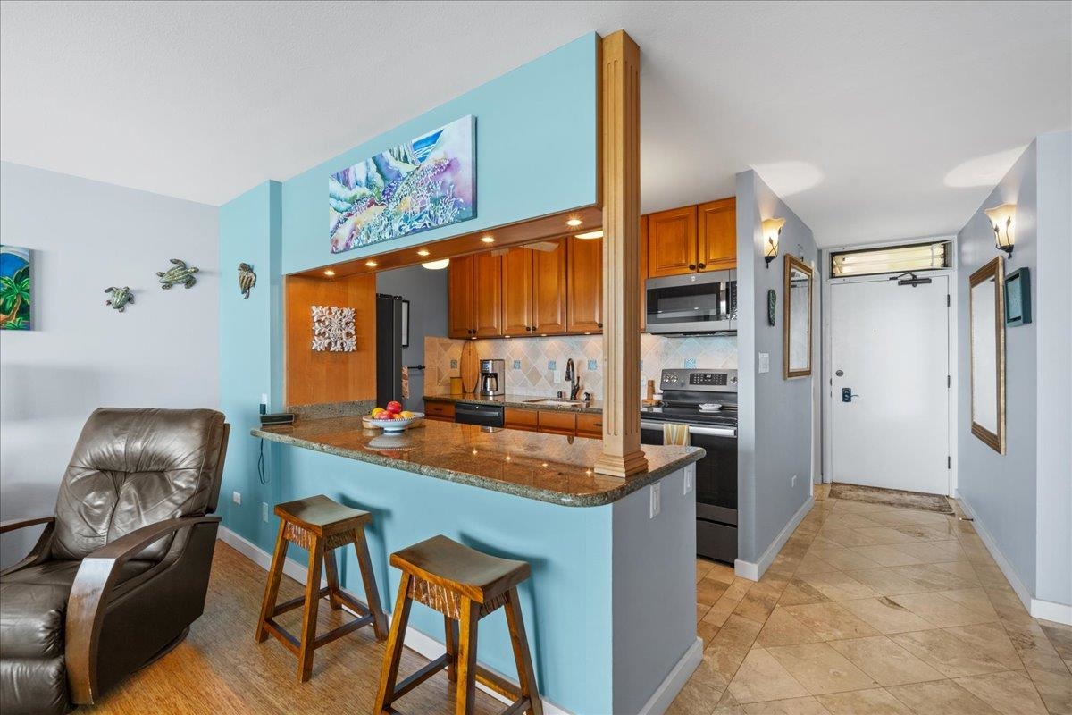 3601 Lower Honoapiilani Road, Unit 201 Lahaina, HI 96761 - Photo 15 of 37 a kitchen with stainless steel appliances granite countertop a sink refrigerator and cabinets