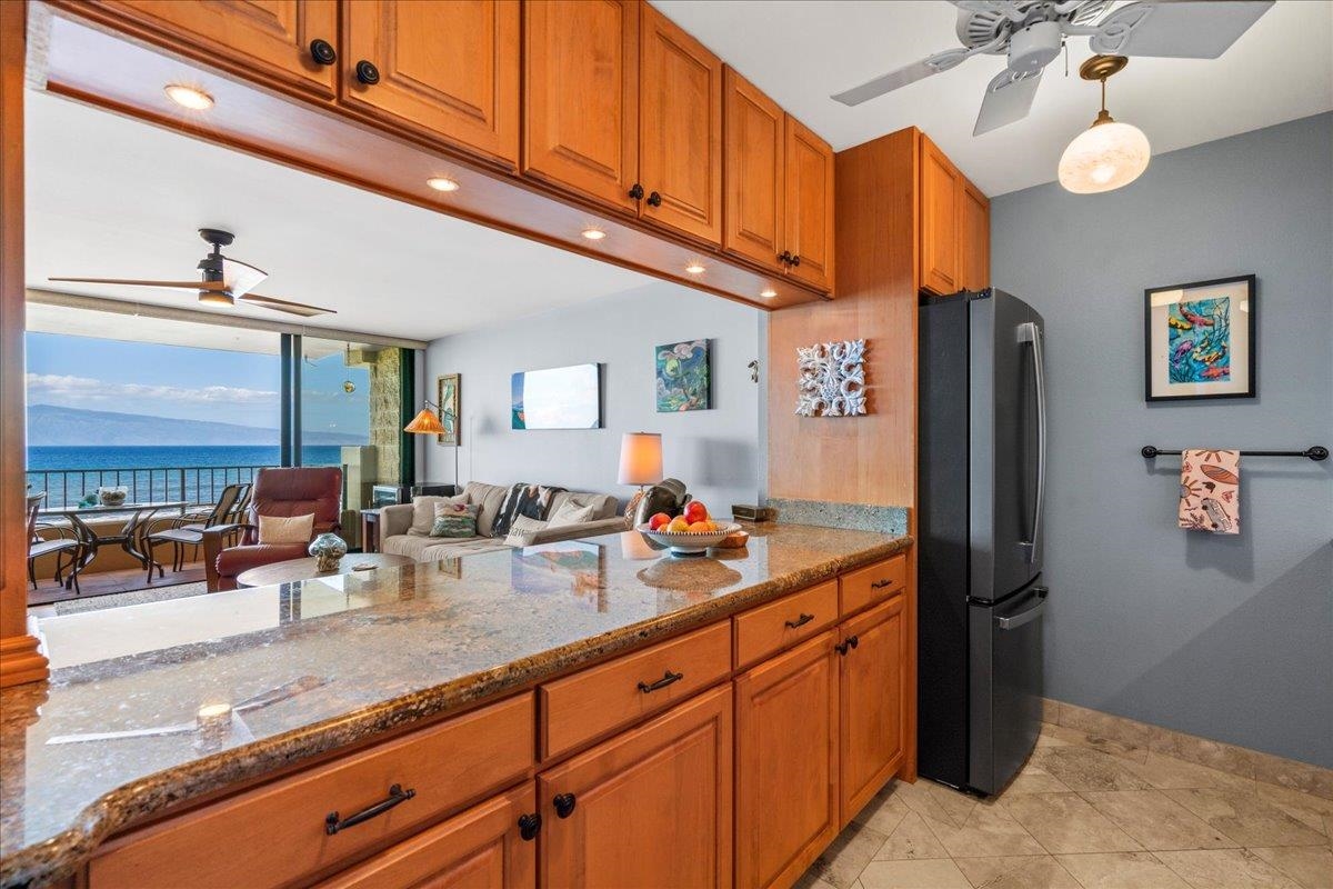 3601 Lower Honoapiilani Road, Unit 201 Lahaina, HI 96761 - Photo 16 of 37 a kitchen with stainless steel appliances granite countertop a refrigerator and a sink