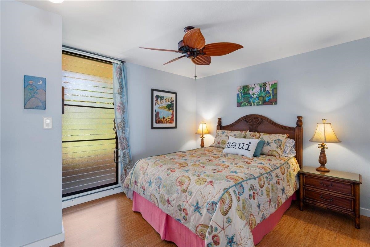 3601 Lower Honoapiilani Road, Unit 201 Lahaina, HI 96761 - Photo 17 of 37 a bedroom with a bed and a chandelier