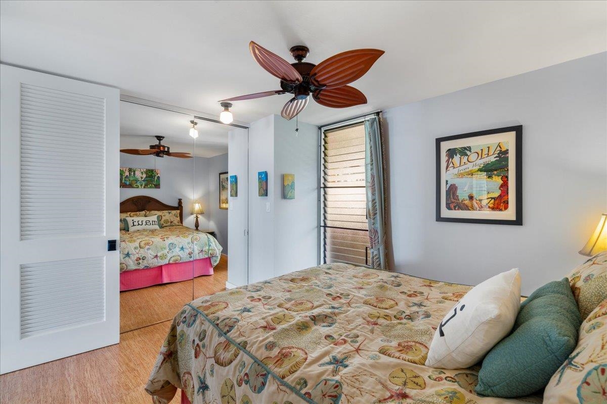 3601 Lower Honoapiilani Road, Unit 201 Lahaina, HI 96761 - Photo 19 of 37 a bedroom that has a bed and a chandelier